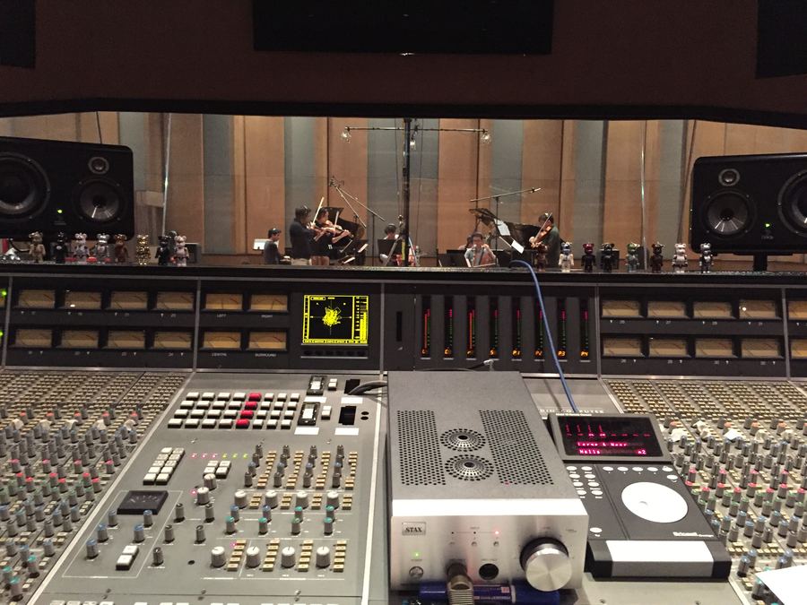 Large-format console facing an orchestra through the glass