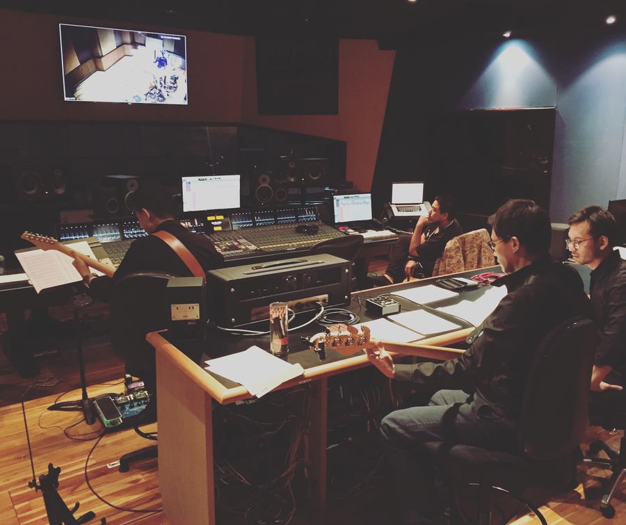 Producer and engineer working in a busy control room