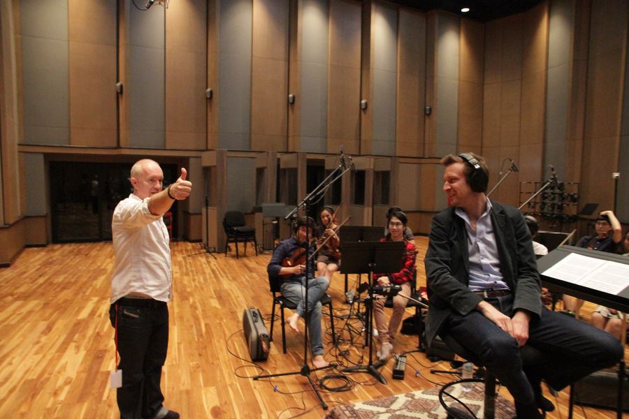 Engineer directing musicians in the live room