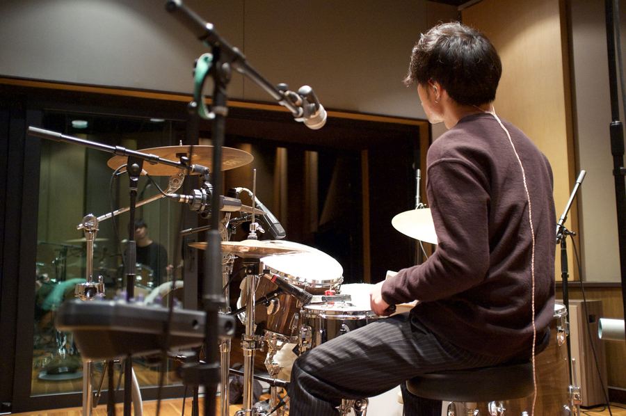 Drummer tracking in a booth with close microphones