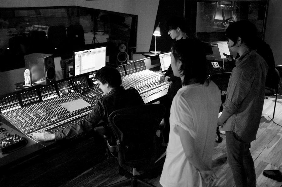 Engineers gathered around the console in the control room