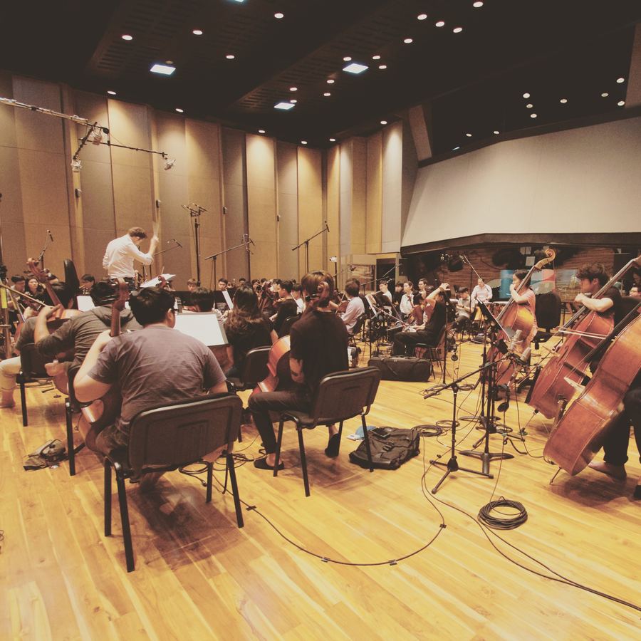Orchestra in the live room, conductor on the podium