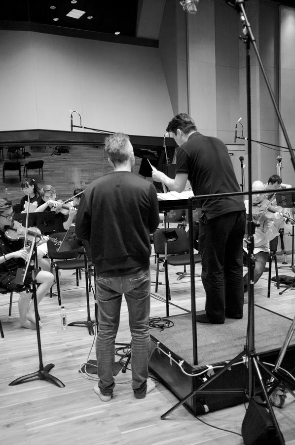 Engineer and conductor checking parts at the podium before a take