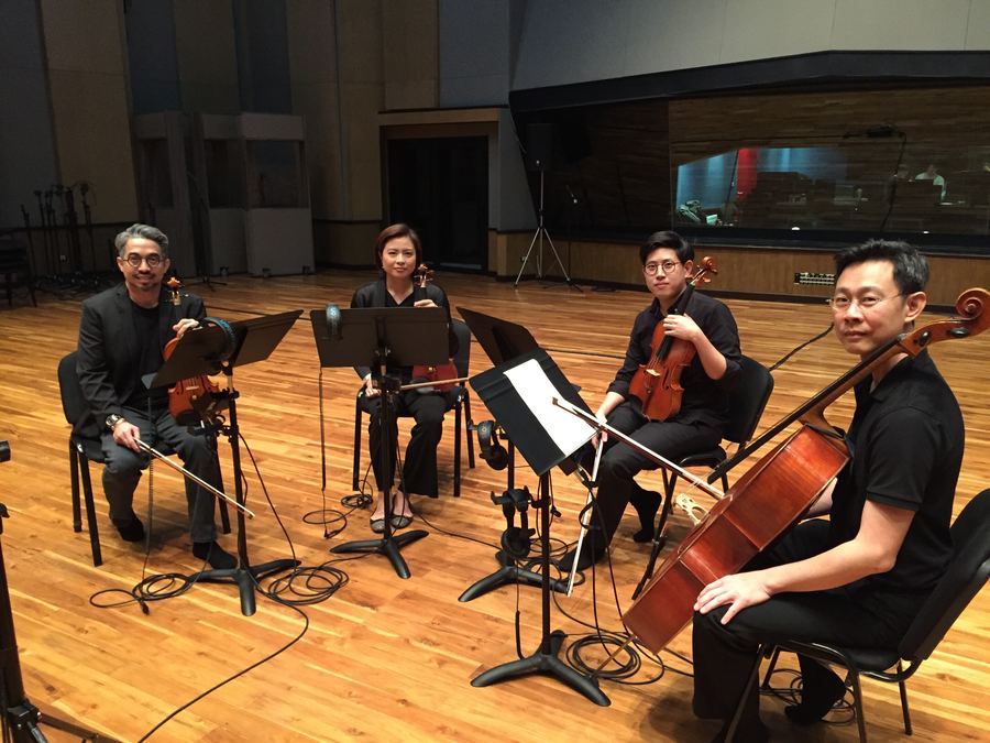 String quartet seated in a semicircle in the live room