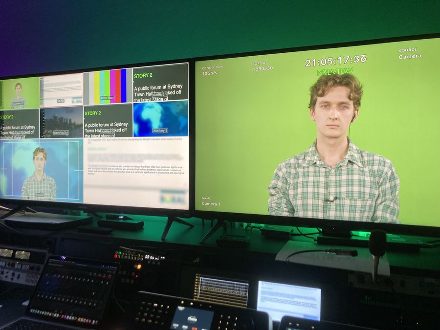 Presenter on the green-screen news set, seen from the gallery