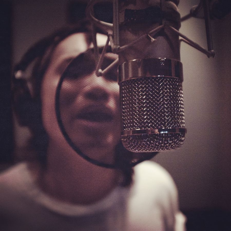 Singer at a valve microphone with a pop shield